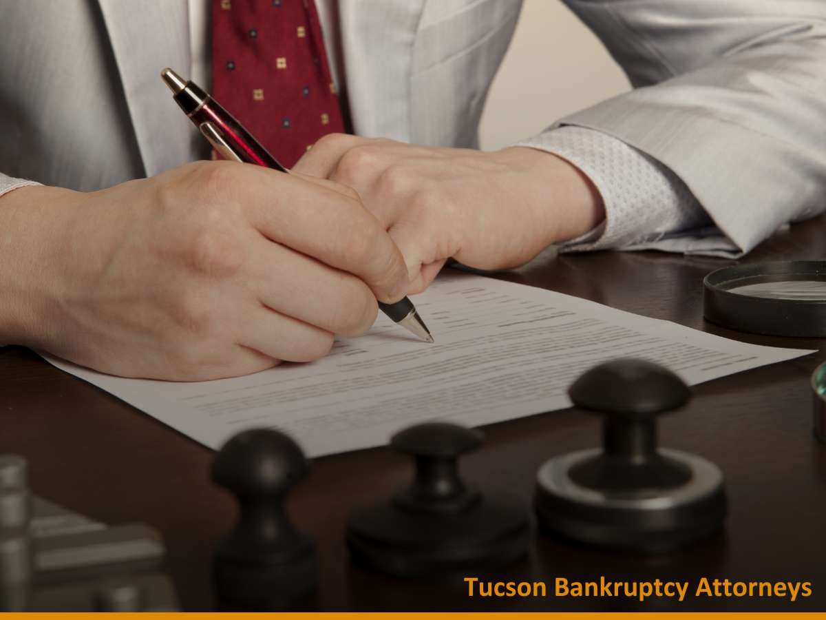 Lawyer signing documents for a Bankruptcy Filing case at Tucson Bankruptcy Attorneys' office